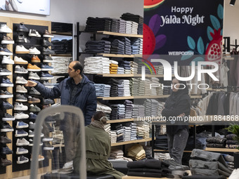 A young Iranian couple shops during Yalda Night celebrations at the Iran Mall shopping mall in northwestern Tehran, Iran, on December 20, 20...