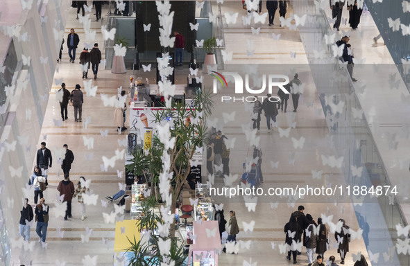 Iranian shoppers walk at the Iran Mall shopping mall in northwestern Tehran, Iran, on December 20, 2024, during Yalda Night celebrations. Ya...