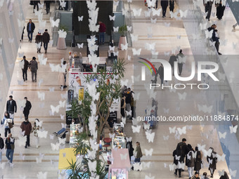 Iranian shoppers walk at the Iran Mall shopping mall in northwestern Tehran, Iran, on December 20, 2024, during Yalda Night celebrations. Ya...