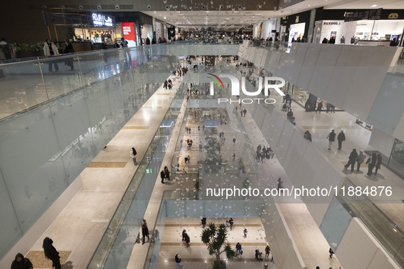 Iranian shoppers walk at the Iran Mall shopping mall in northwestern Tehran, Iran, on December 20, 2024, during Yalda Night celebrations. Ya...