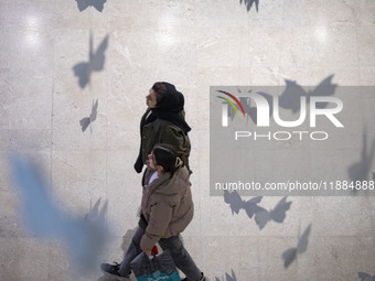 Two Iranian women walk at the Iran Mall shopping mall in northwestern Tehran, Iran, on December 20, 2024, during Yalda Night celebrations. Y...