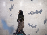 Two Iranian women walk at the Iran Mall shopping mall in northwestern Tehran, Iran, on December 20, 2024, during Yalda Night celebrations. Y...