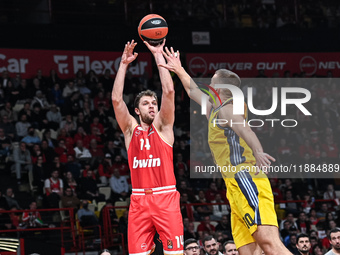 Sasha Vezenkov of Olympiacos Piraeus competes with Tim Schneider of Alba Berlin during the Euroleague, Round 17 match between Olympiacos Pir...