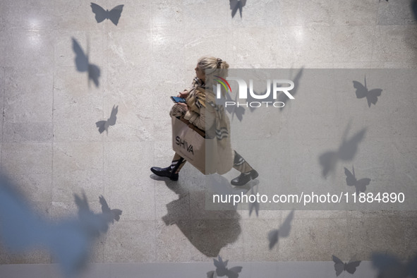 An Iranian woman walks at the Iran Mall shopping mall in northwestern Tehran, Iran, on December 20, 2024, during Yalda Night celebrations. Y...