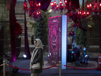 An Iranian woman walks past Yalda Night decorations at the Iran Mall shopping mall in northwestern Tehran, Iran, on December 20, 2024, durin...