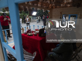 An Iranian family poses for a photograph with a Yalda table at the Iran Mall shopping mall in northwestern Tehran, Iran, on December 20, 202...