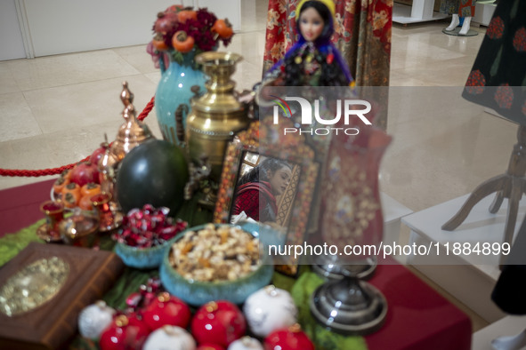 A young Iranian woman walks past a Yalda table while visiting the Iran Mall shopping mall in northwestern Tehran, Iran, on December 20, 2024...