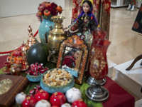 A young Iranian woman walks past a Yalda table while visiting the Iran Mall shopping mall in northwestern Tehran, Iran, on December 20, 2024...