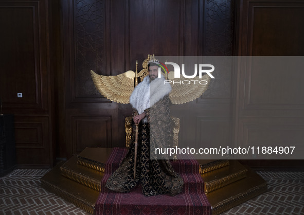 An Iranian man wears symbolic dresses as a King and poses for a photograph while visiting the Iran Mall shopping mall in northwestern Tehran...