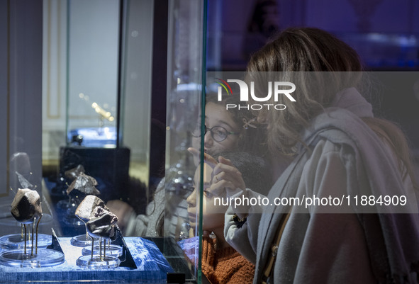 An Iranian family observes meteorites at the meteorite museum while visiting the Iran Mall shopping mall in northwestern Tehran, Iran, on De...