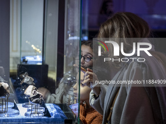 An Iranian family observes meteorites at the meteorite museum while visiting the Iran Mall shopping mall in northwestern Tehran, Iran, on De...