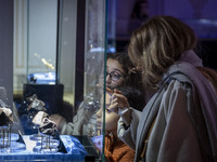 An Iranian family observes meteorites at the meteorite museum while visiting the Iran Mall shopping mall in northwestern Tehran, Iran, on De...