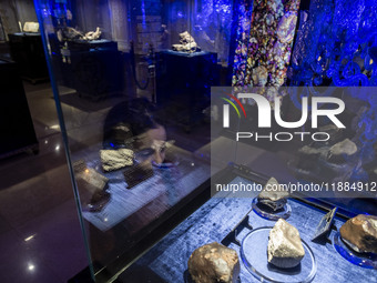 A young Iranian girl observes meteorites at the meteorite museum while visiting the Iran Mall shopping mall in northwestern Tehran, Iran, on...