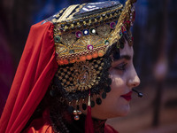 A young Iranian woman wearing a traditional hat looks on as she performs during Yalda Night celebrations at the Iran Mall shopping mall in n...