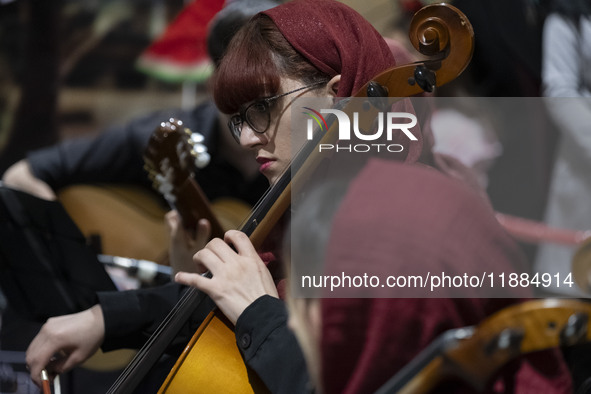 A young Iranian female musician performs during Yalda Night celebrations at the Iran Mall shopping mall in northwestern Tehran, Iran, on Dec...