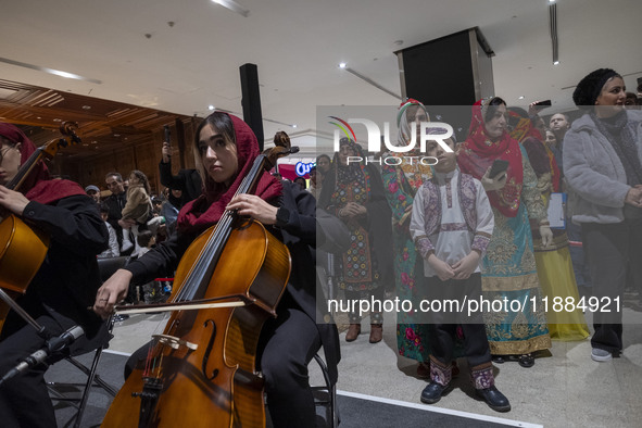 A young Iranian female musician performs during Yalda Night celebrations at the Iran Mall shopping mall in northwestern Tehran, Iran, on Dec...