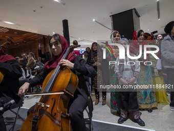 A young Iranian female musician performs during Yalda Night celebrations at the Iran Mall shopping mall in northwestern Tehran, Iran, on Dec...