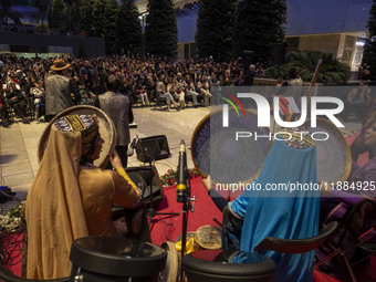 Women wearing Iranian traditional dresses play traditional musical instruments during Yalda Night celebrations at the Iran Mall shopping mal...