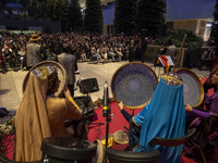 Women wearing Iranian traditional dresses play traditional musical instruments during Yalda Night celebrations at the Iran Mall shopping mal...