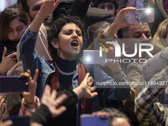 A young Iranian woman reacts while participating in Yalda Night celebrations at the Iran Mall shopping mall in northwestern Tehran, Iran, on...