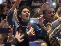 A young Iranian woman reacts while participating in Yalda Night celebrations at the Iran Mall shopping mall in northwestern Tehran, Iran, on...