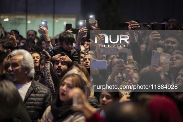 Iranian families capture videos with their cellphones while participating in Yalda Night celebrations at the Iran Mall shopping mall in nort...