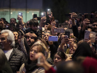 Iranian families capture videos with their cellphones while participating in Yalda Night celebrations at the Iran Mall shopping mall in nort...