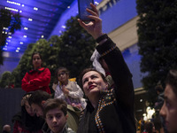 An Iranian woman records videos with her cellphone while participating in Yalda Night celebrations at the Iran Mall shopping mall in northwe...