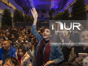 Iranian women react while participating in Yalda Night celebrations at the Iran Mall shopping mall in northwestern Tehran, Iran, on December...