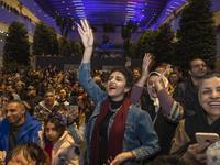 Iranian women react while participating in Yalda Night celebrations at the Iran Mall shopping mall in northwestern Tehran, Iran, on December...