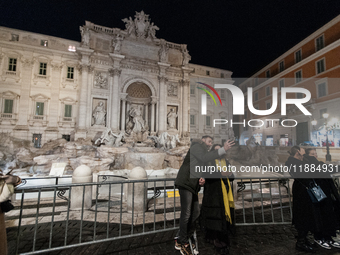 Restoration work on the Trevi Fountain is completed. Workers clean the lower part and fill the joints over two months, and they remove the s...