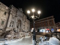 Restoration work on the Trevi Fountain is completed. Workers clean the lower part and fill the joints over two months, and they remove the s...