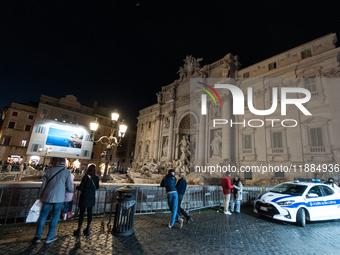 Restoration work on the Trevi Fountain is completed. Workers clean the lower part and fill the joints over two months, and they remove the s...