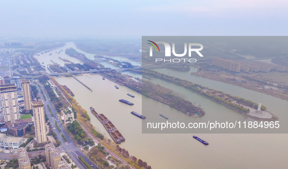 Cargo ships loaded with agricultural supplies, building materials, coal, and other goods sail on the Beijing-Hangzhou Grand Canal in Suqian,...