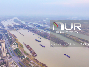 Cargo ships loaded with agricultural supplies, building materials, coal, and other goods sail on the Beijing-Hangzhou Grand Canal in Suqian,...