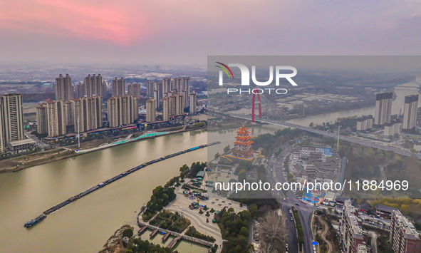 Cargo ships loaded with agricultural supplies, building materials, coal, and other goods sail on the Beijing-Hangzhou Grand Canal in Suqian,...