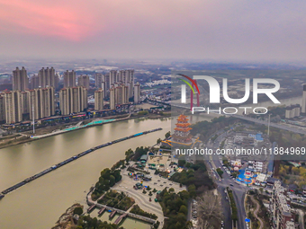 Cargo ships loaded with agricultural supplies, building materials, coal, and other goods sail on the Beijing-Hangzhou Grand Canal in Suqian,...