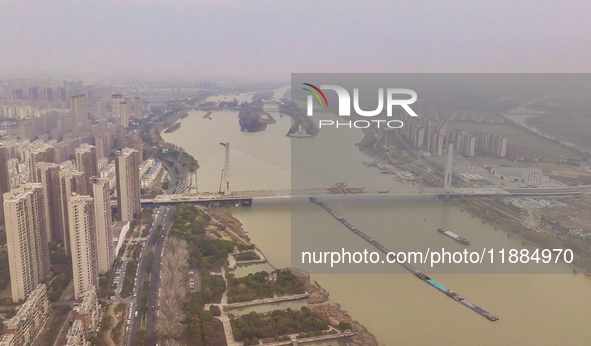 Cargo ships loaded with agricultural supplies, building materials, coal, and other goods sail on the Beijing-Hangzhou Grand Canal in Suqian,...