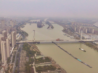 Cargo ships loaded with agricultural supplies, building materials, coal, and other goods sail on the Beijing-Hangzhou Grand Canal in Suqian,...