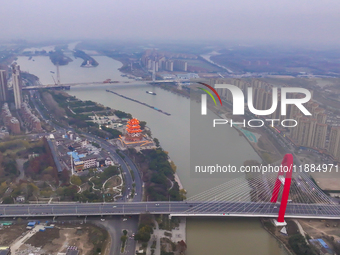 Cargo ships loaded with agricultural supplies, building materials, coal, and other goods sail on the Beijing-Hangzhou Grand Canal in Suqian,...