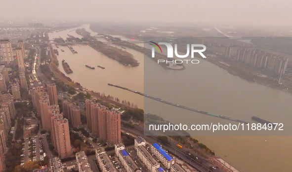 Cargo ships loaded with agricultural supplies, building materials, coal, and other goods sail on the Beijing-Hangzhou Grand Canal in Suqian,...