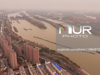 Cargo ships loaded with agricultural supplies, building materials, coal, and other goods sail on the Beijing-Hangzhou Grand Canal in Suqian,...