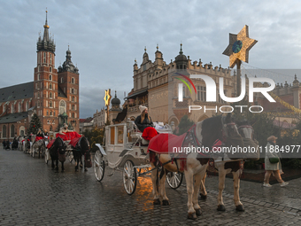 KRAKOW, POLAND - DECEMBER 20:   
Horse-drawn carriages waiting for tourists at Krakow's Main Market Square, on December 20, 2024 in Krakow,...