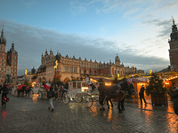 KRAKOW, POLAND - DECEMBER 20:   
Horse-drawn carriages waiting for tourists at Krakow's Main Market Square, on December 20, 2024 in Krakow,...