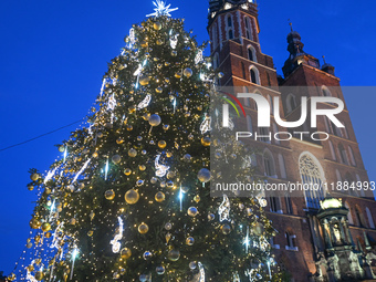 KRAKOW, POLAND - DECEMBER 20:   
An illuminated Christmas tree stands near St. Mary's Basilica in Krakow's UNESCO-listed Main Square, on Dec...