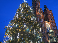 KRAKOW, POLAND - DECEMBER 20:   
An illuminated Christmas tree stands near St. Mary's Basilica in Krakow's UNESCO-listed Main Square, on Dec...