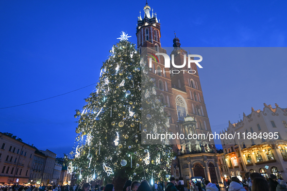 KRAKOW, POLAND - DECEMBER 20:   
An illuminated Christmas tree stands near St. Mary's Basilica in Krakow's UNESCO-listed Main Square, on Dec...