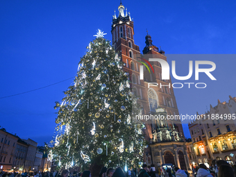 KRAKOW, POLAND - DECEMBER 20:   
An illuminated Christmas tree stands near St. Mary's Basilica in Krakow's UNESCO-listed Main Square, on Dec...