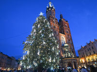 KRAKOW, POLAND - DECEMBER 20:   
An illuminated Christmas tree stands near St. Mary's Basilica in Krakow's UNESCO-listed Main Square, on Dec...