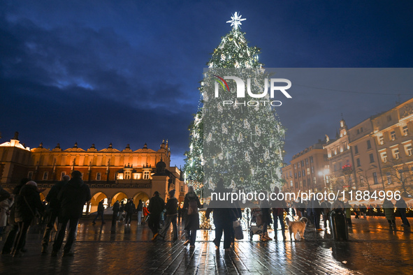 KRAKOW, POLAND - DECEMBER 20:   
An illuminated Christmas tree stands near St. Mary's Basilica in Krakow's UNESCO-listed Main Square, on Dec...